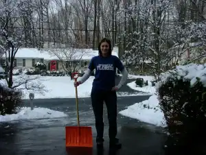 women-clearing-snow-in-driveway